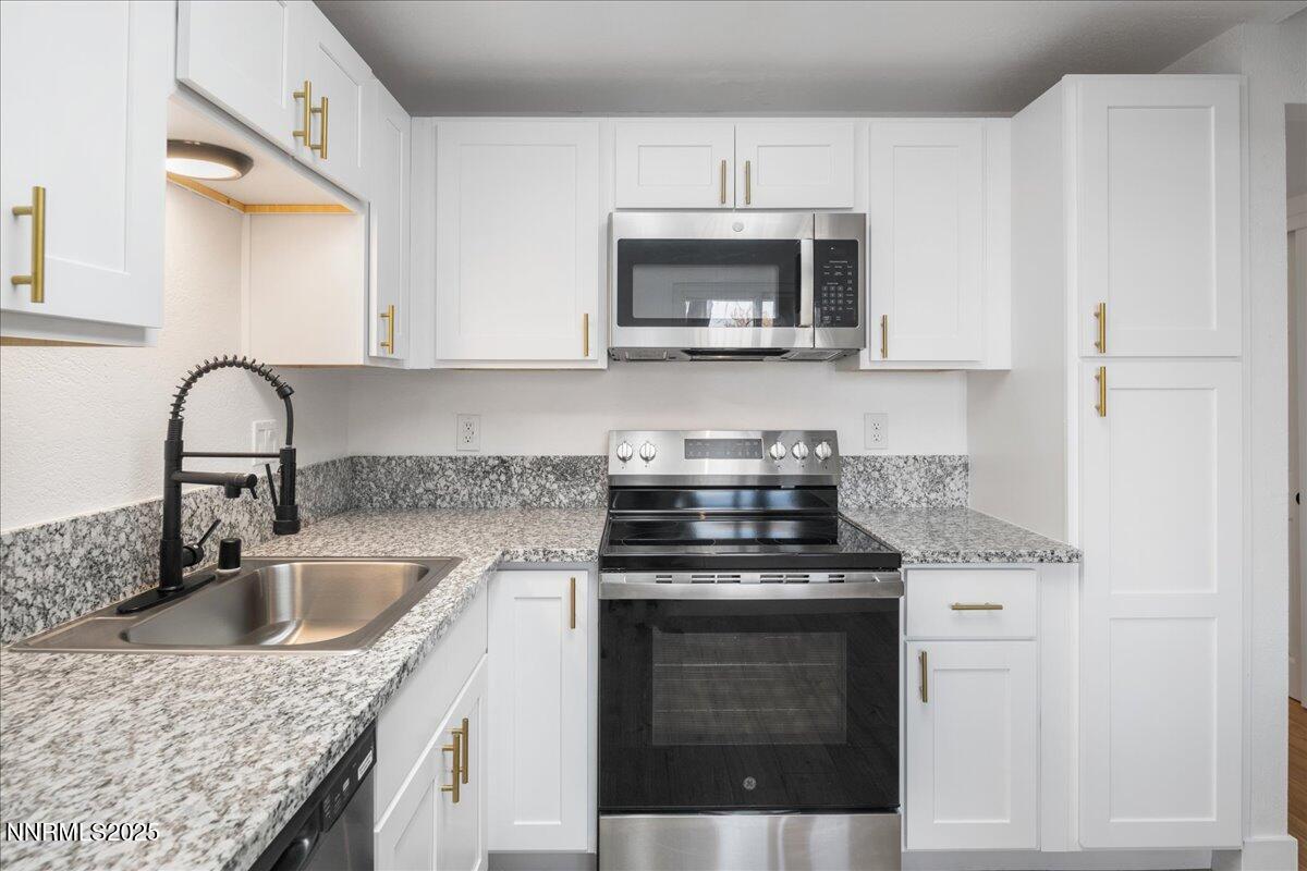 2136 Roundhouse Road Sparks, NV 89431 - Photo 8 of 26 a kitchen with a stove microwave and cabinets