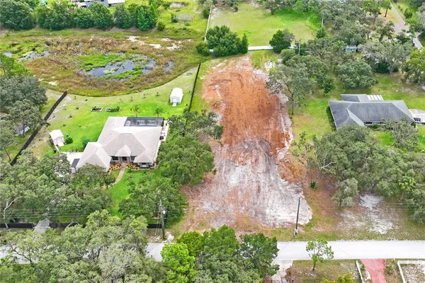 an aerial view of residential house with outdoor space and swimming pool
