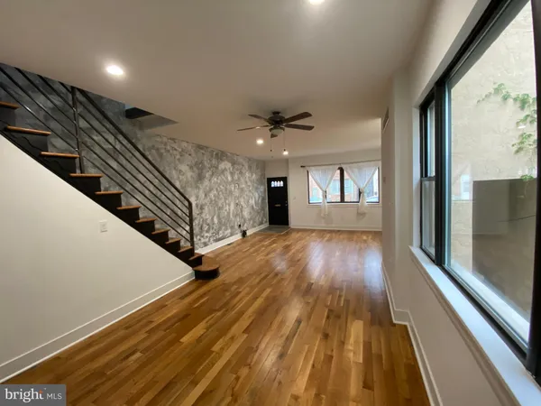 a view of an entryway with wooden floor