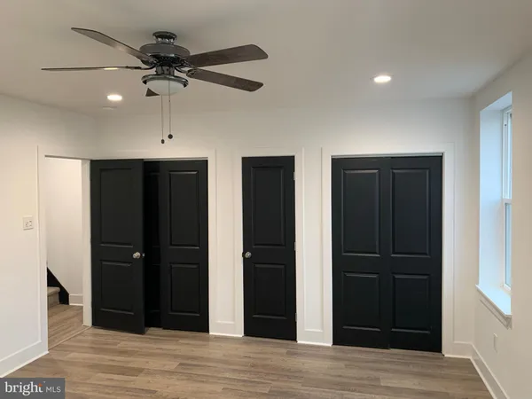 a view of a livingroom with a space wooden floor and closet