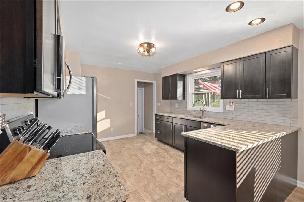 318 Holyoke Road Butler, PA 16001 - Photo 7 of 25 a kitchen with a sink and a refrigerator