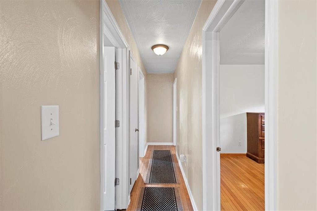 318 Holyoke Road Butler, PA 16001 - Photo 10 of 25 a view of a hallway with wooden floor and staircase