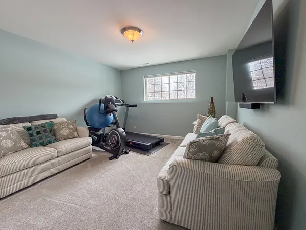 a living room with furniture a window and a flat screen tv