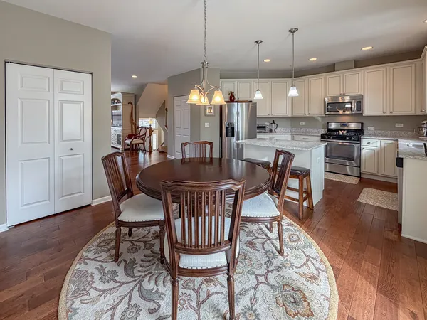a dining room with furniture and wooden floor