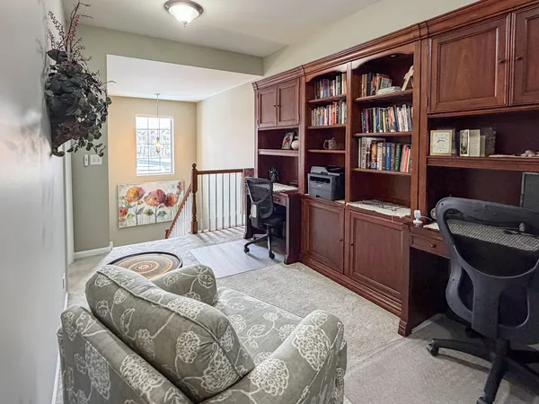 a bedroom with a bed and a book shelf