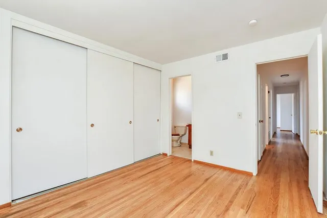 a bedroom with a bed and a desk