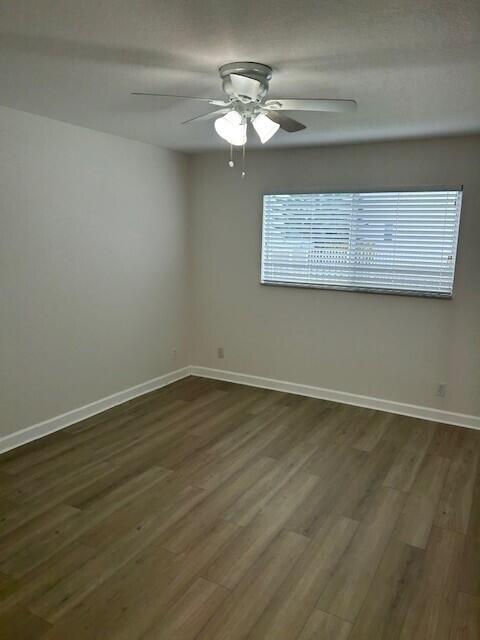 10330 North Military Trail, Unit 6A Palm Beach Gardens, FL 33410 - Photo 7 of 11 a view of a room with wooden floor and fan