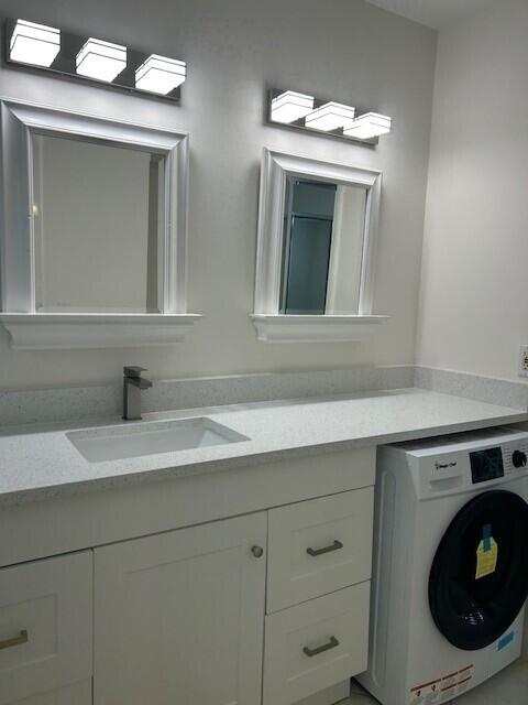 10330 North Military Trail, Unit 6A Palm Beach Gardens, FL 33410 - Photo 9 of 11 a bathroom with a sink and a mirror