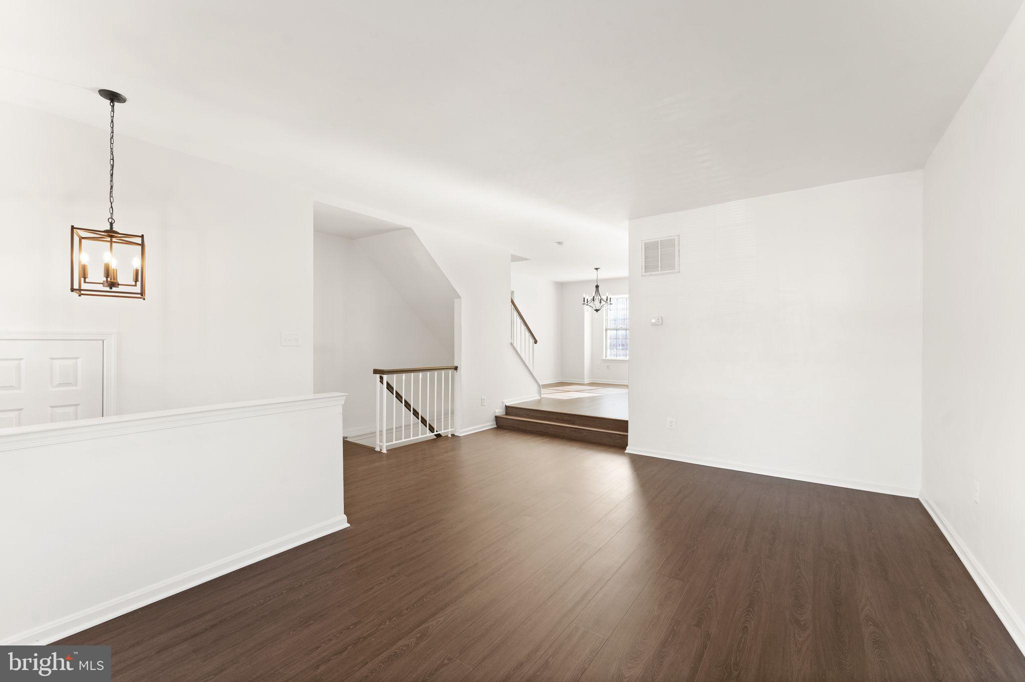 6001 Little Brook Court Clifton, VA 20124 - Photo 11 of 46 a view of an empty room with wooden floor and a window