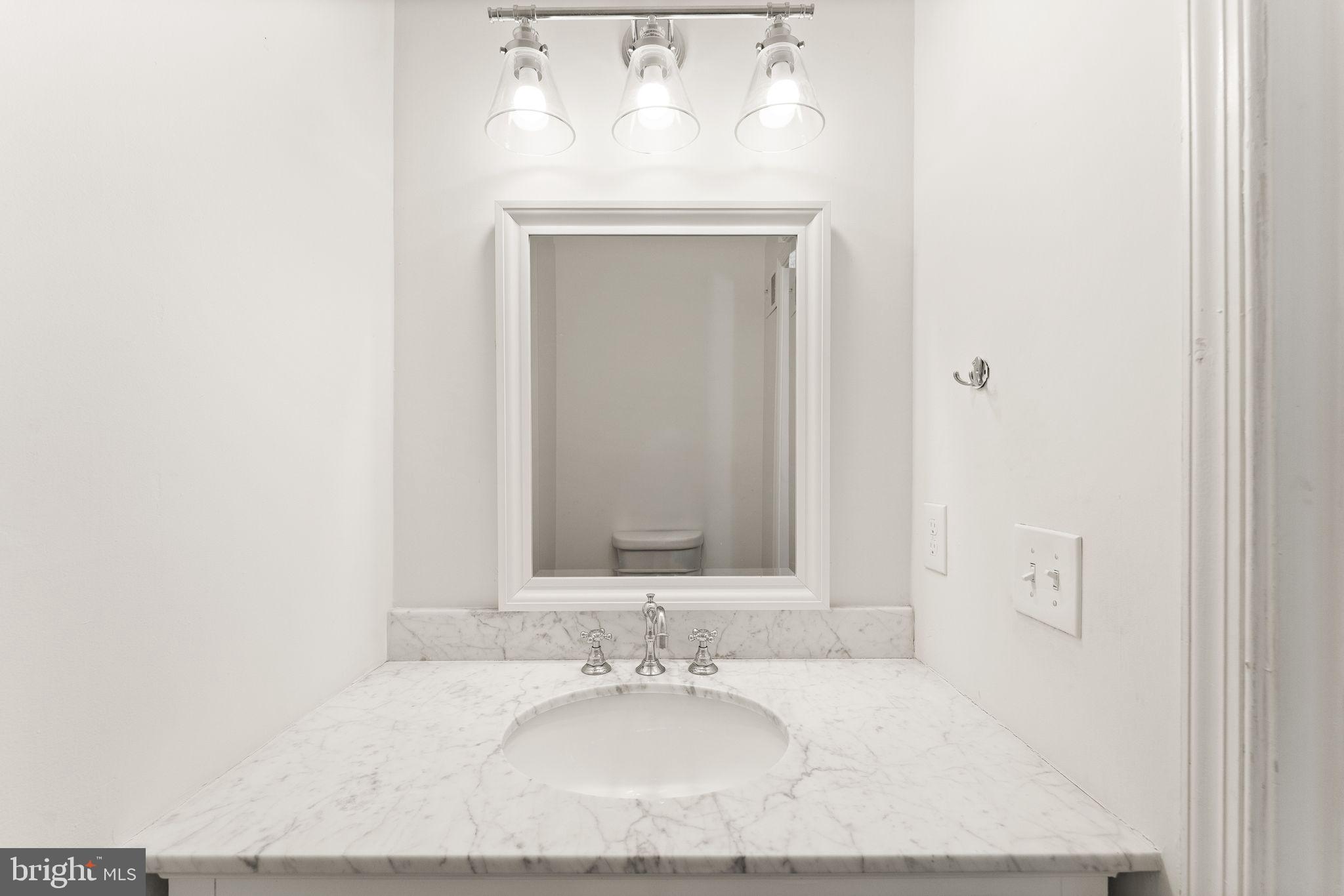 6001 Little Brook Court Clifton, VA 20124 - Photo 16 of 46 a bathroom with a granite countertop sink and a mirror