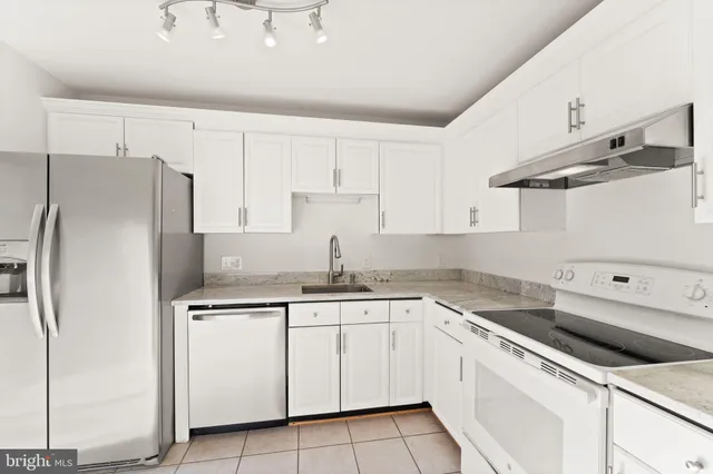 a kitchen with cabinets appliances and a sink
