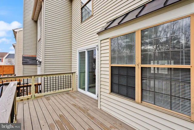 a view of a house with a small yard and wooden fence
