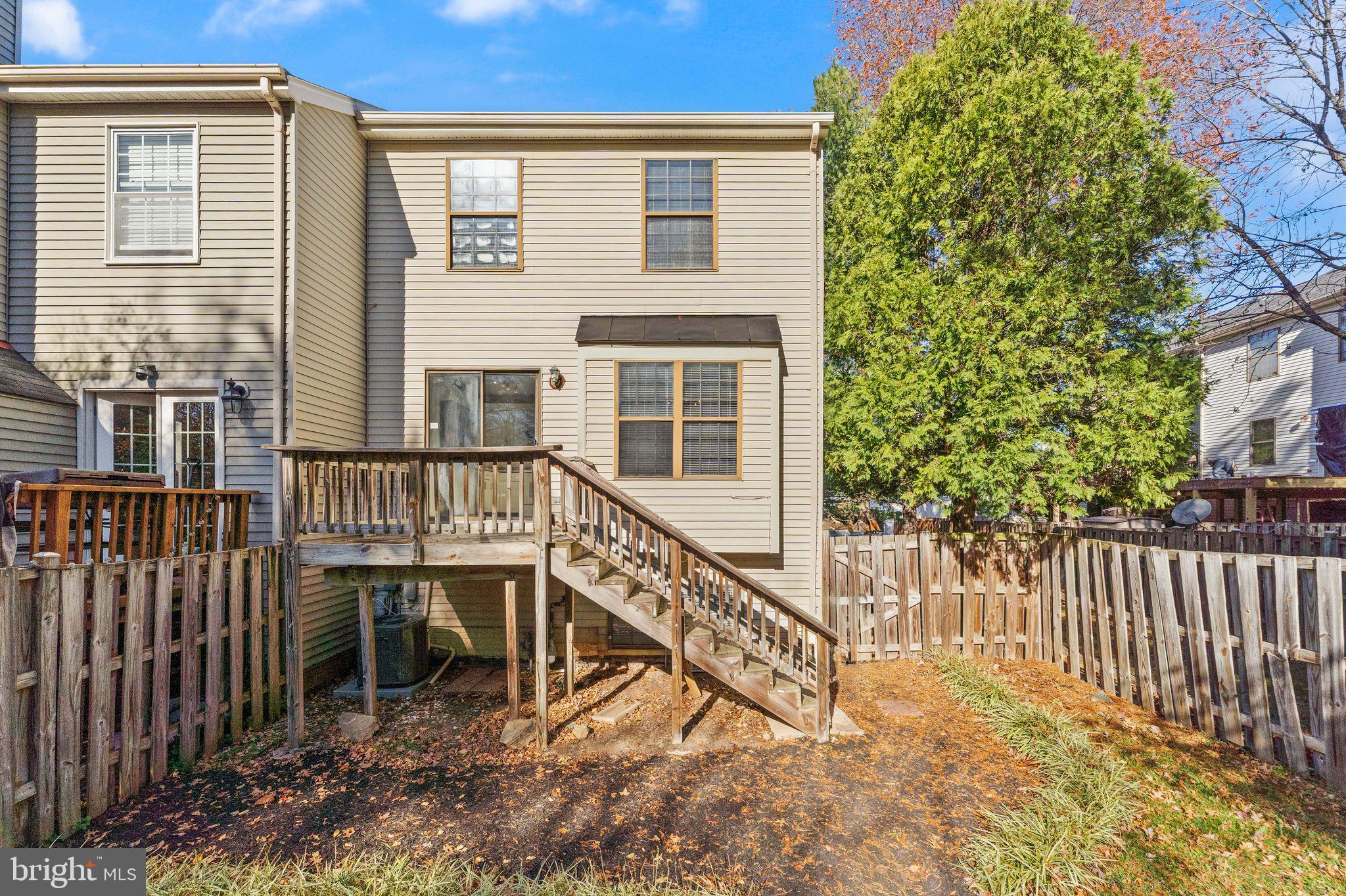 6001 Little Brook Court Clifton, VA 20124 - Photo 38 of 46 a view of a house with wooden deck and a yard