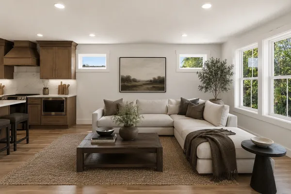 a living room with furniture and large windows