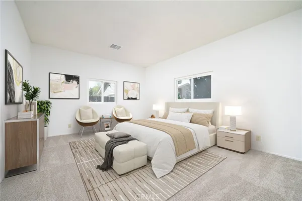 a spacious bedroom with a bed and a couch