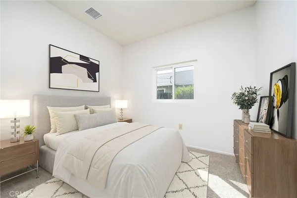 a bedroom with a bed and a couch