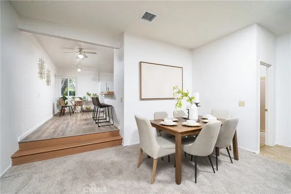 a dining room with furniture and wooden floor