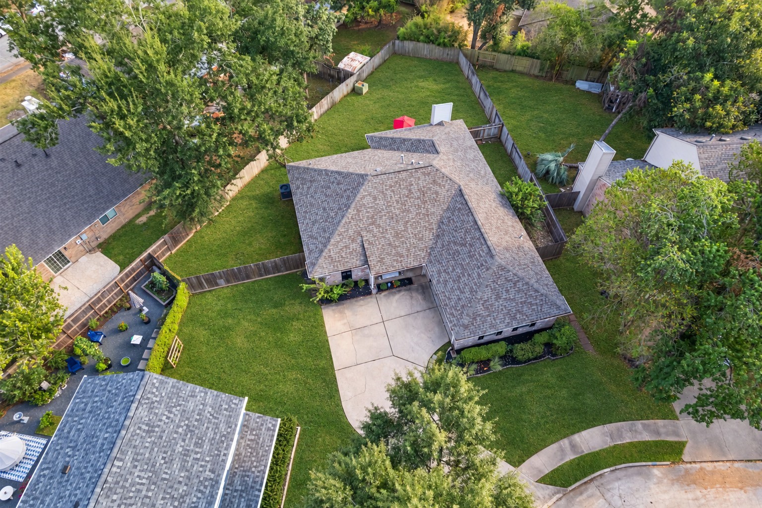 9107 Towerstone Court Spring, TX 77379 - Photo 35 of 42 Expansive fenced backyard with lush green lawn and privacy, perfect for outdoor activities and relaxation.