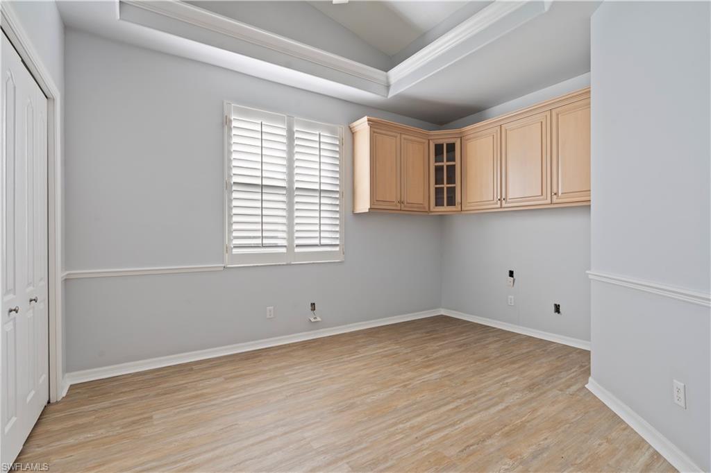 20751 Rivers Ford Estero, FL 33928 - Photo 26 of 36 Laundry room featuring vaulted ceiling, light wood-style flooring, and a raised ceiling