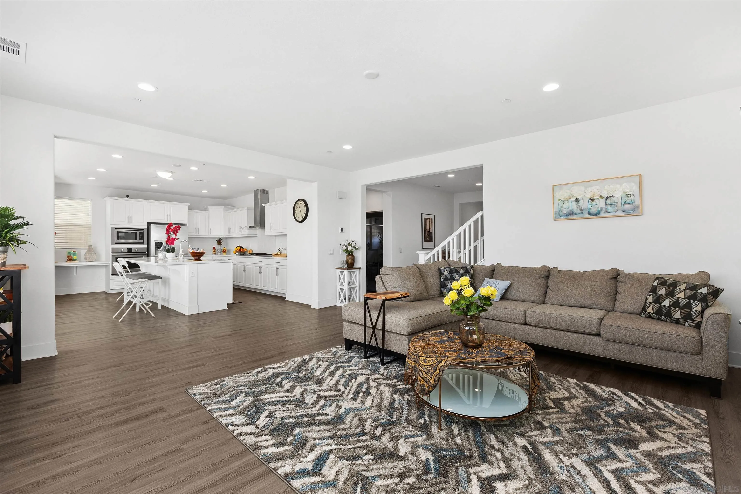 35732 Garrano Lane Fallbrook, CA 92028 - Photo 11 of 44 a living room with furniture and a dining table with wooden floor