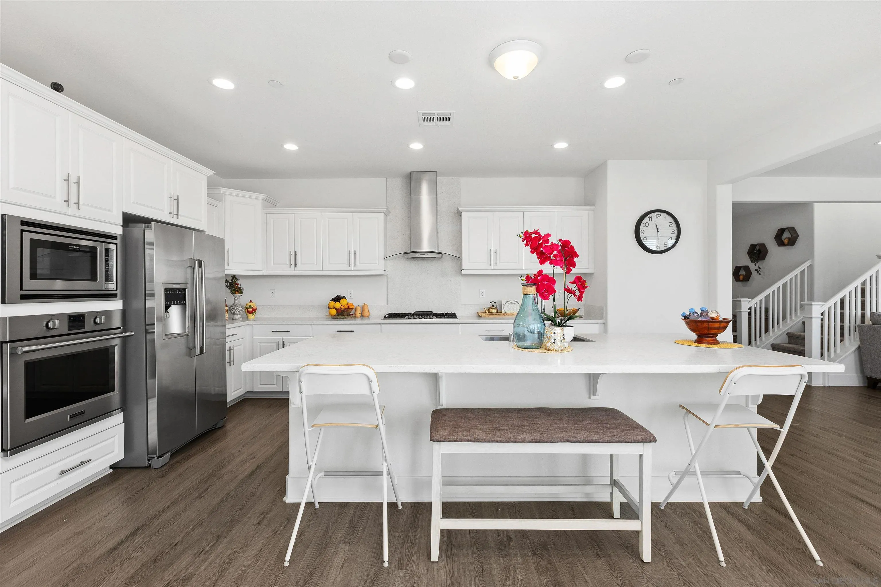 35732 Garrano Lane Fallbrook, CA 92028 - Photo 13 of 44 a kitchen with white cabinets and stainless steel appliances
