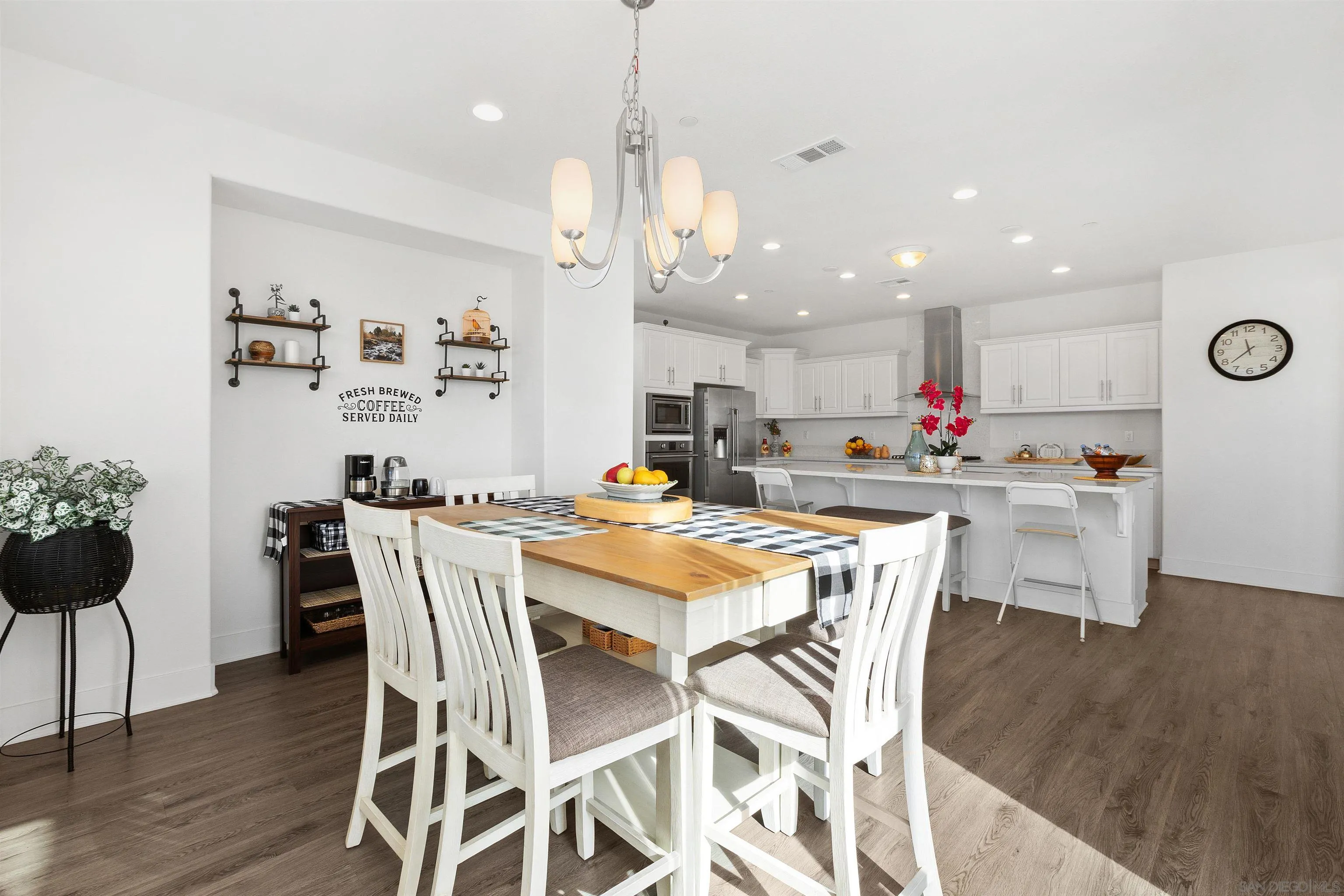 35732 Garrano Lane Fallbrook, CA 92028 - Photo 17 of 44 a dining room with stainless steel appliances kitchen island a table and chairs
