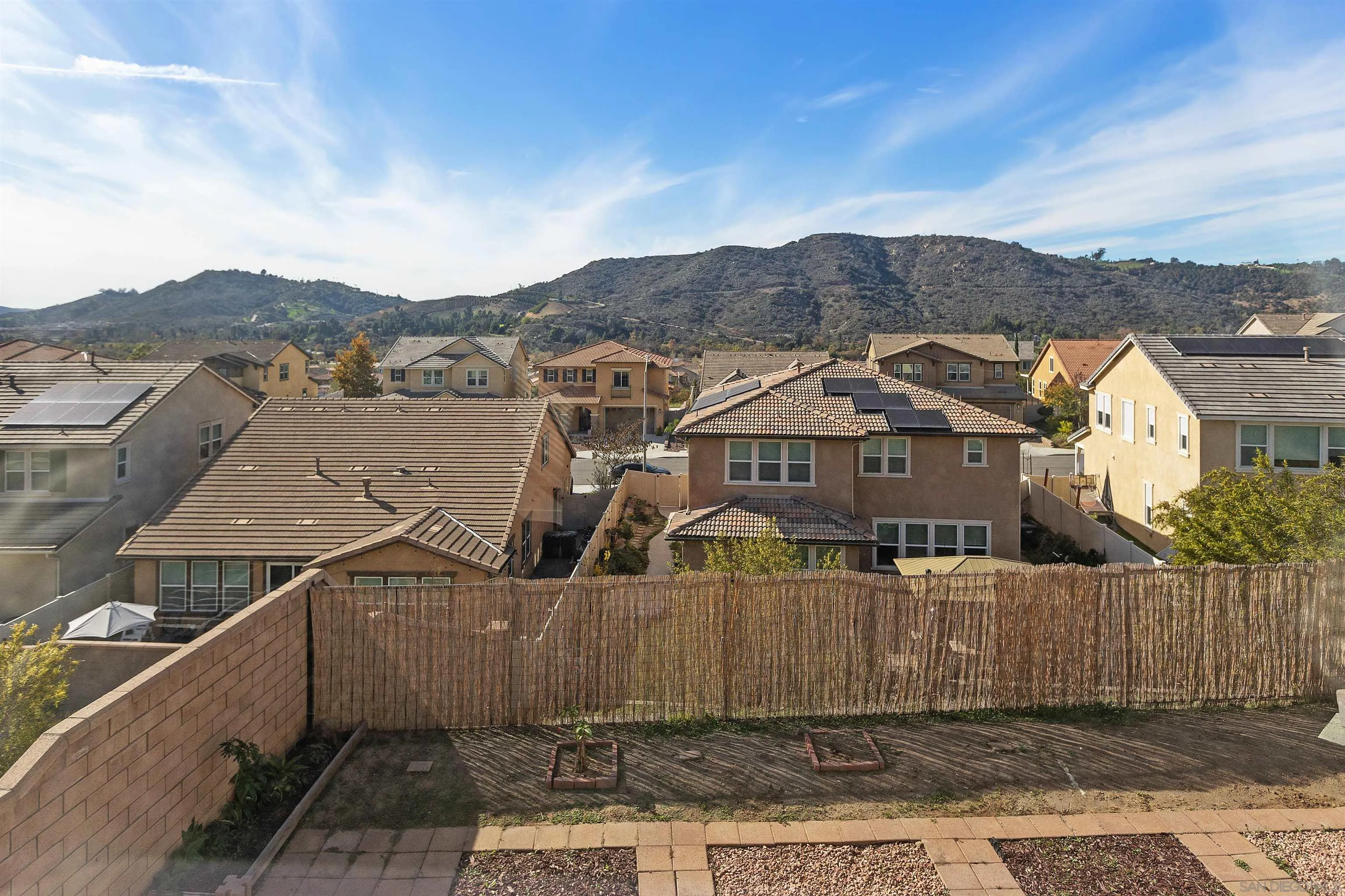 35732 Garrano Lane Fallbrook, CA 92028 - Photo 29 of 44 a view of a big house with a mountain in the background