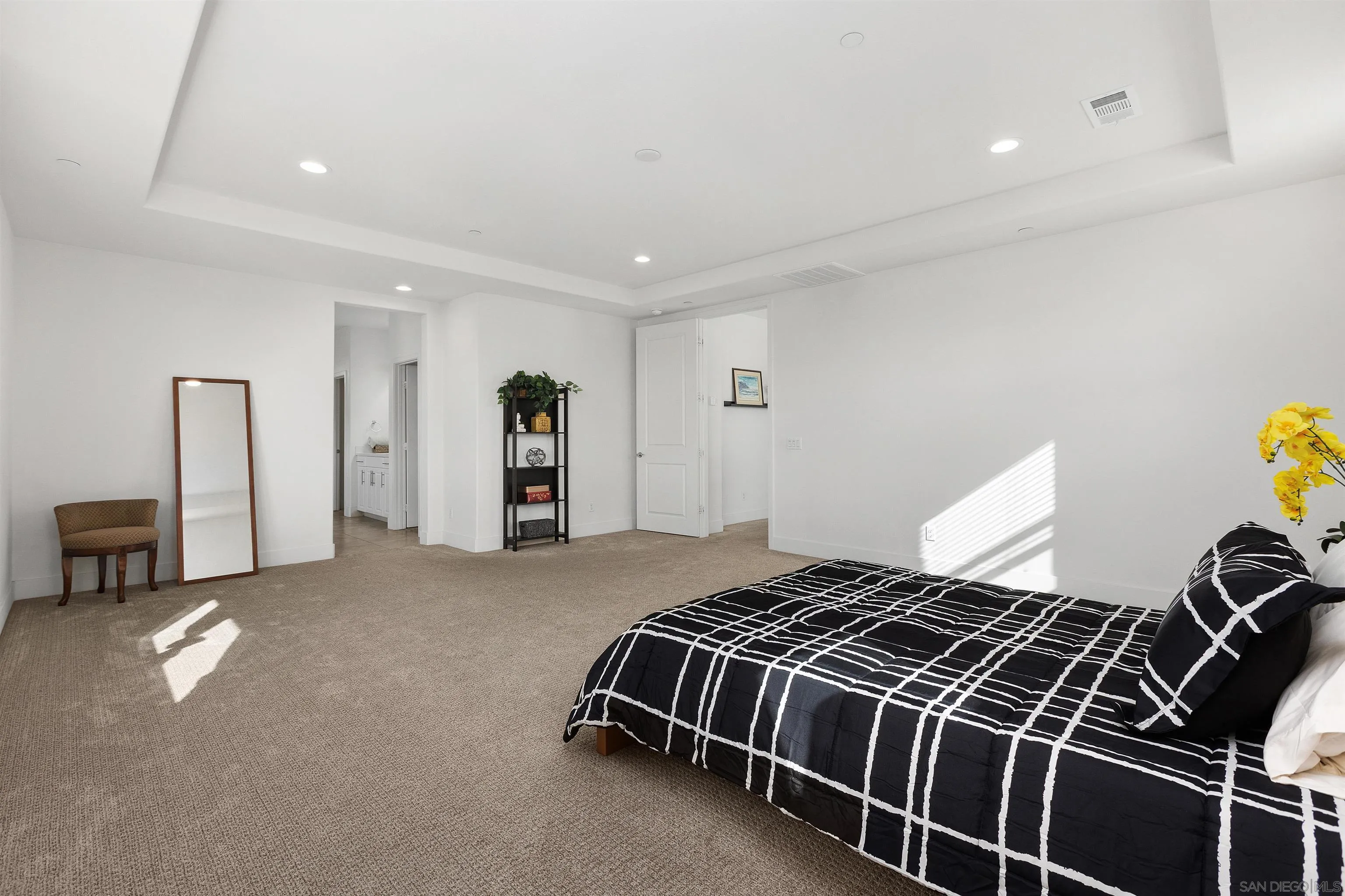 35732 Garrano Lane Fallbrook, CA 92028 - Photo 33 of 44 a spacious bedroom with a bed and a chandelier