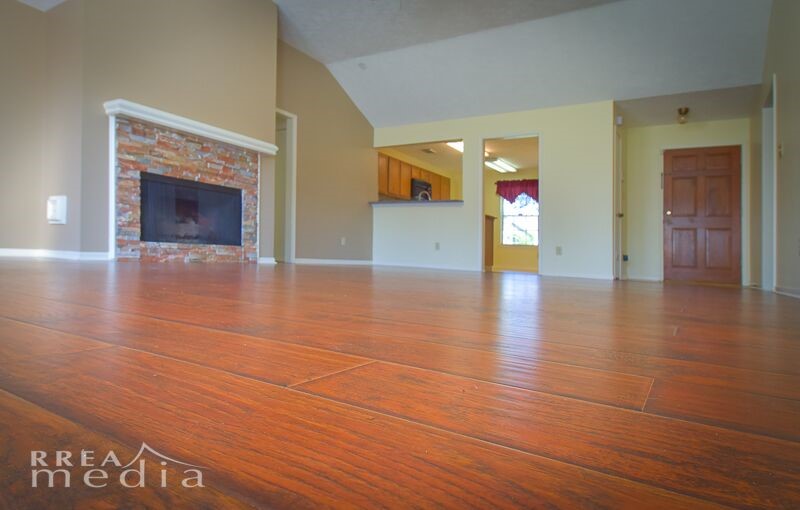 19723 Glenfinch Lane Spring, TX 77379 - Photo 4 of 39 Large living room has scraped, hardwood looking laminate flooring