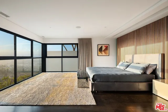 a bedroom with a large bed and a large window