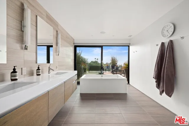 a large white kitchen with a large window
