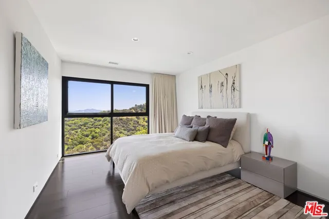 a bedroom with a large bed and a large window