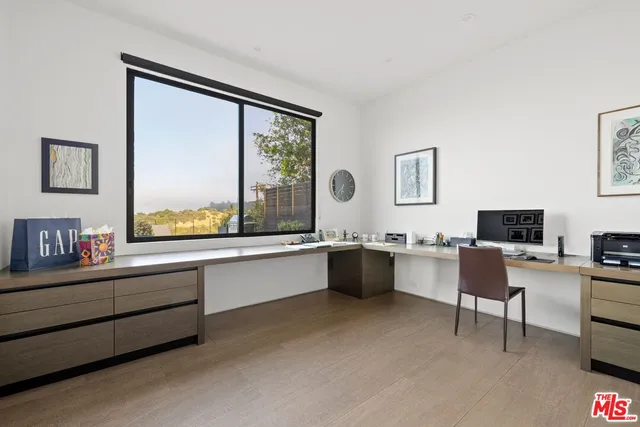 a large white kitchen with a large window