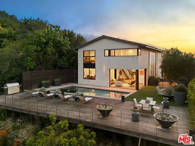 a view of house with outdoor space and sitting area
