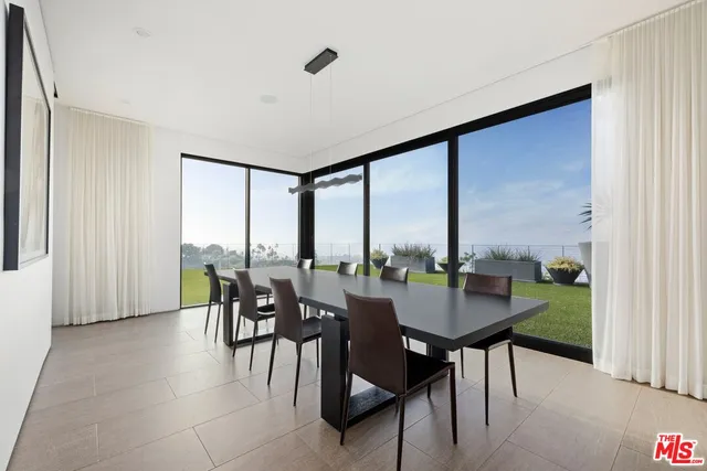 a dining room with furniture window and outside view