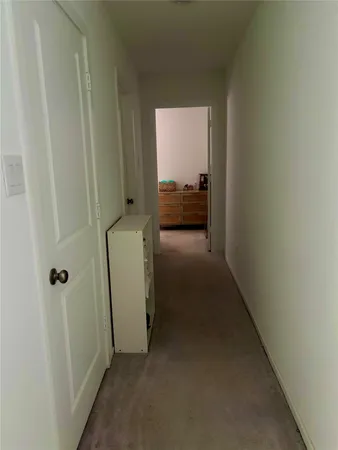 a view of a hallway with a room