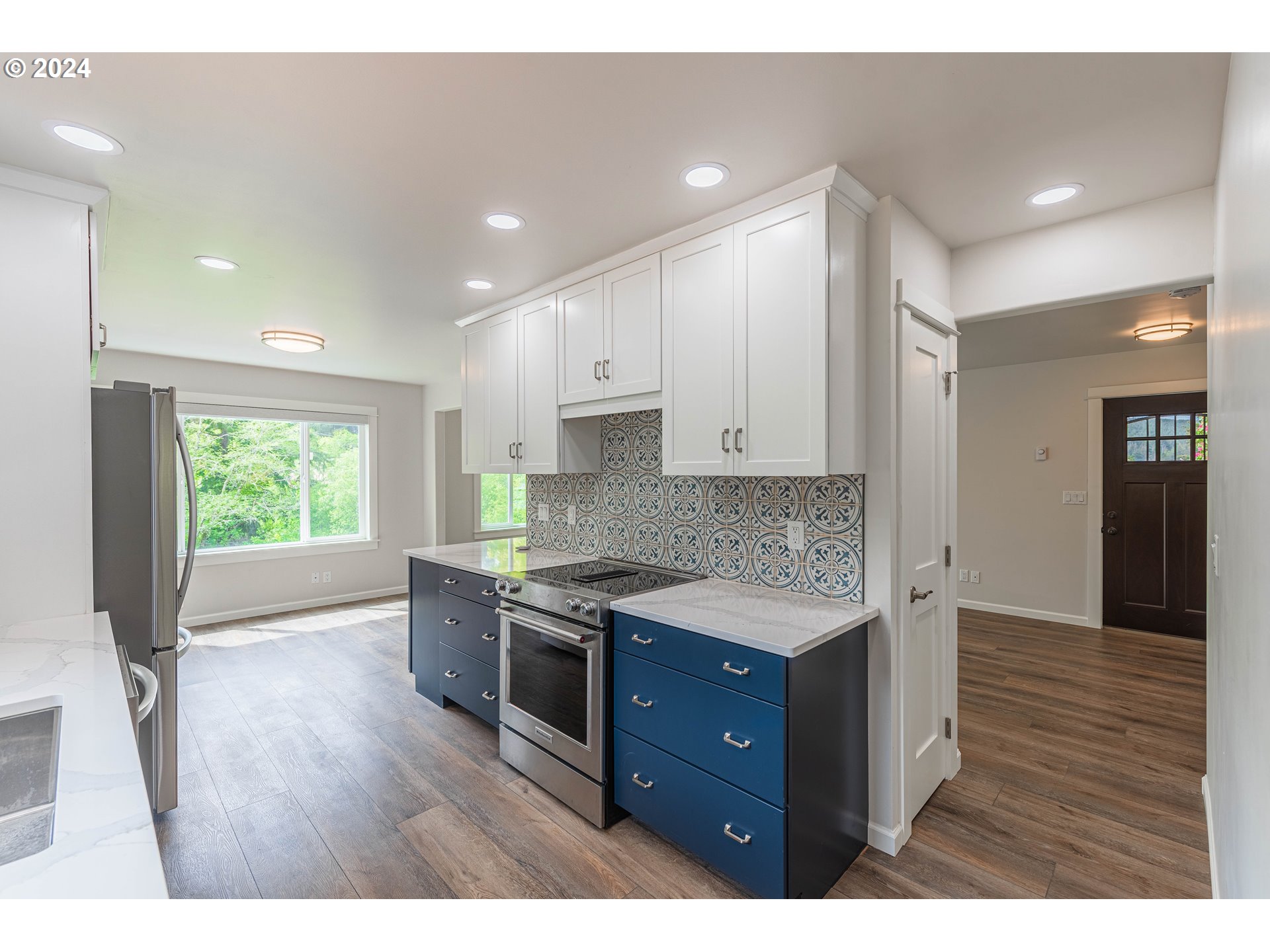 66013 North Bay Road North Bend, OR 97459 - Photo 13 of 48 a kitchen with stainless steel appliances granite countertop wooden cabinets a stove top oven a sink and dishwasher