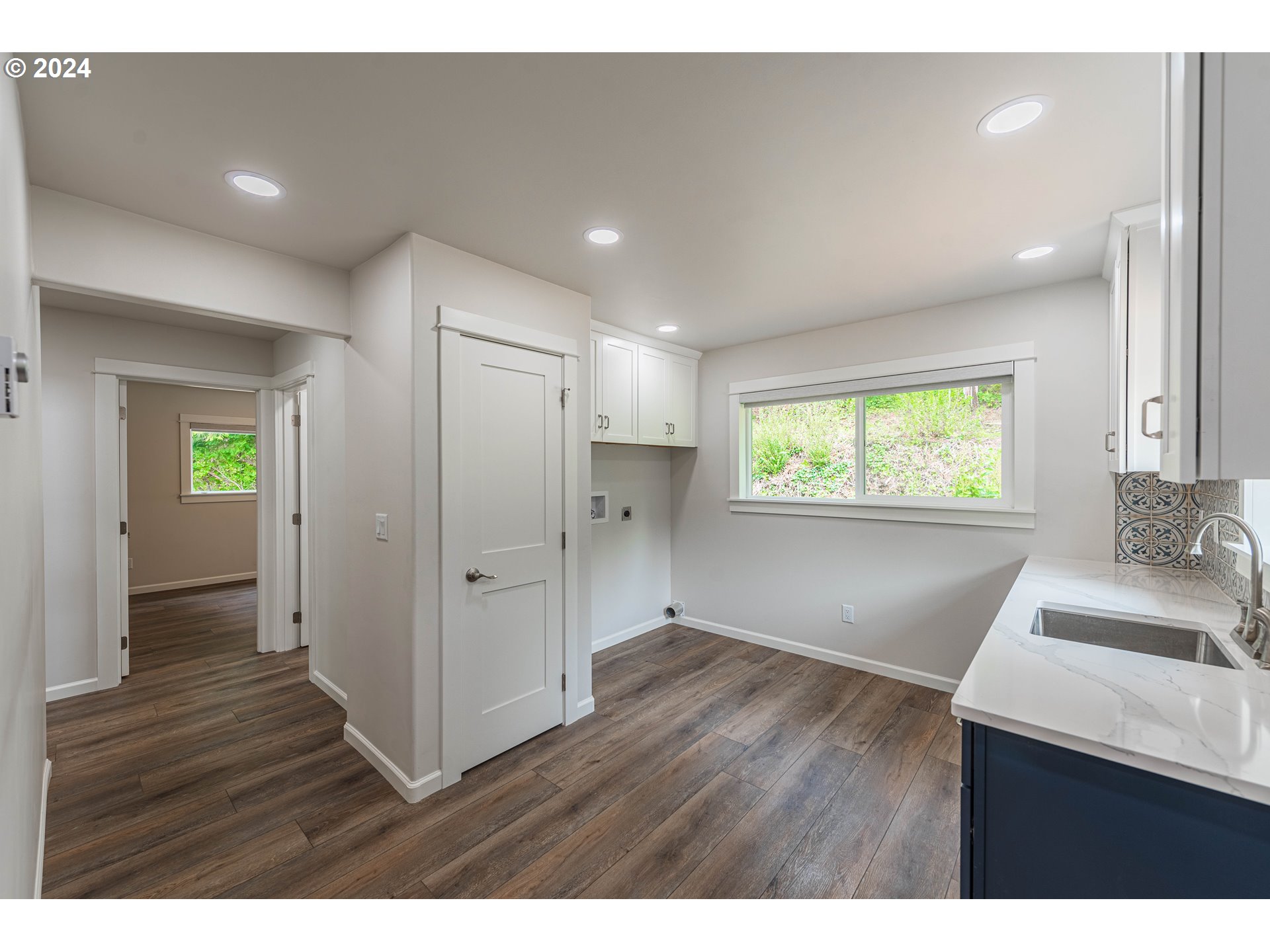 66013 North Bay Road North Bend, OR 97459 - Photo 18 of 48 a view of an empty room with wooden floor and a window