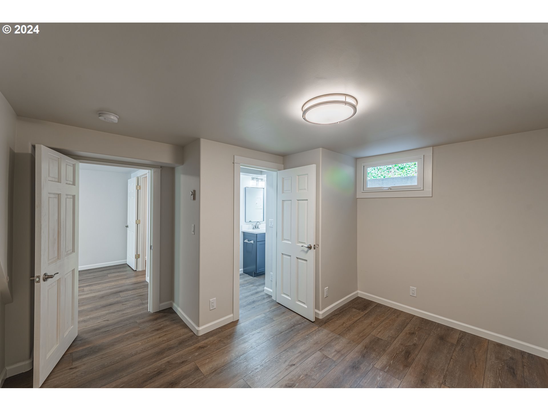 66013 North Bay Road North Bend, OR 97459 - Photo 22 of 48 a view of an empty room with wooden floor and a window
