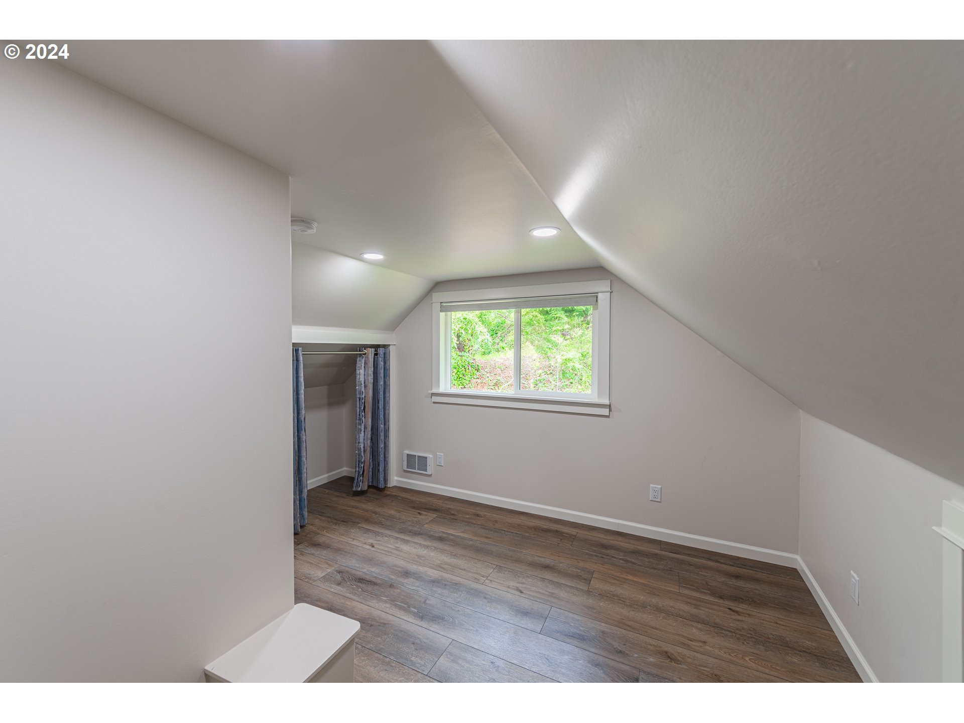 66013 North Bay Road North Bend, OR 97459 - Photo 26 of 48 a view of an empty room with wooden floor and a window