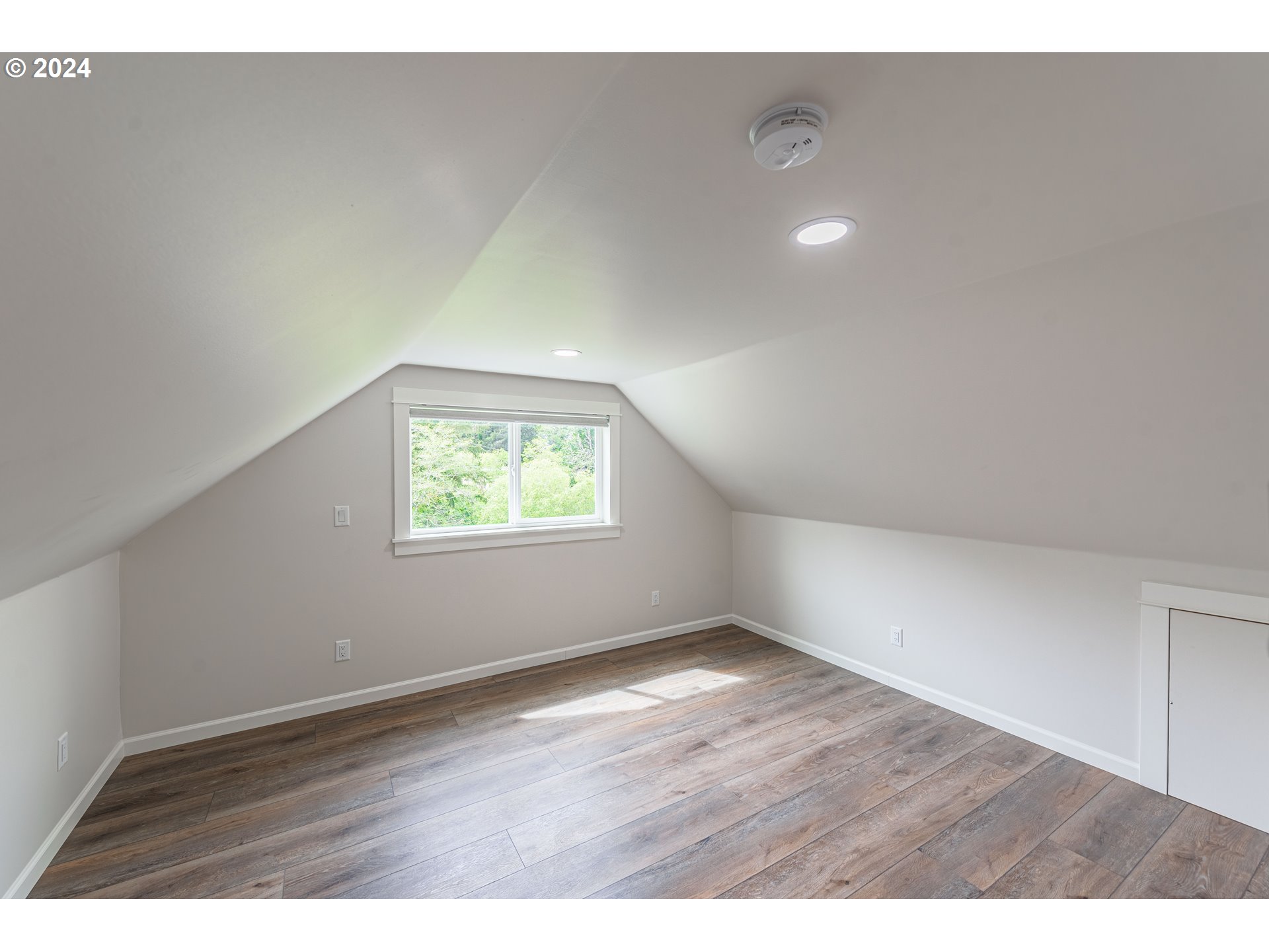 66013 North Bay Road North Bend, OR 97459 - Photo 29 of 48 a view of an empty room with wooden floor and a window