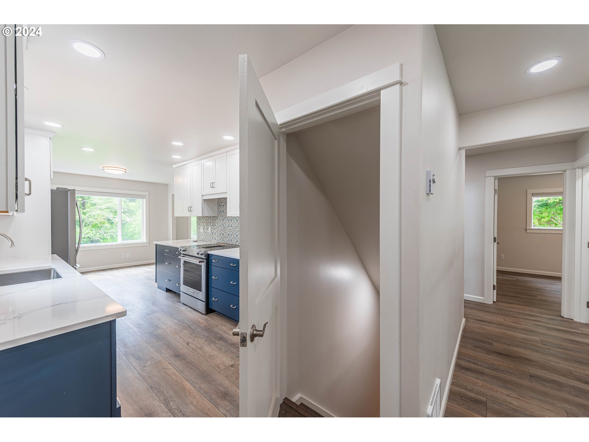 66013 North Bay Road North Bend, OR 97459 - Photo 33 of 48 a open hall with wooden floor and a kitchen