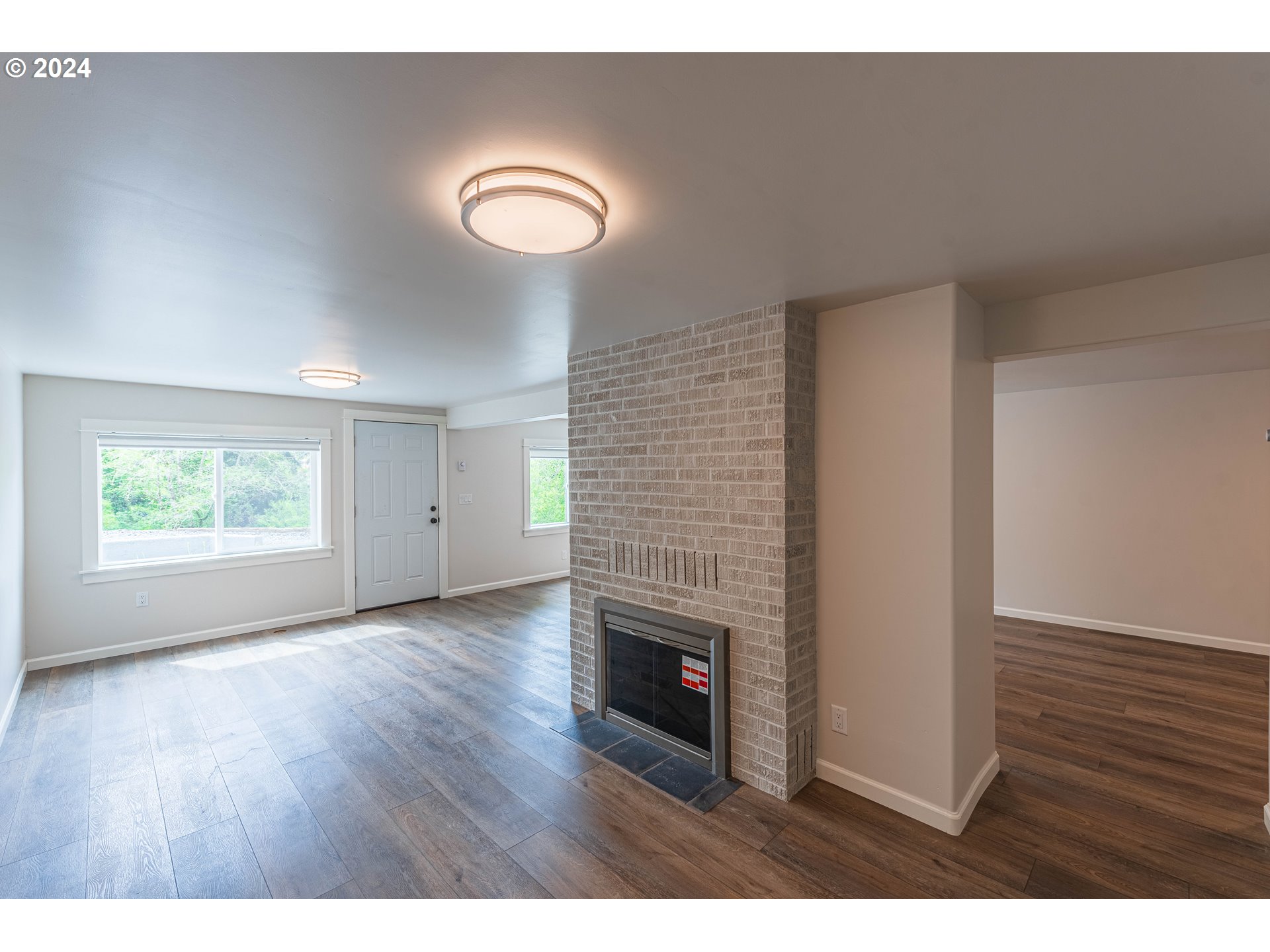 66013 North Bay Road North Bend, OR 97459 - Photo 37 of 48 a view interior of a house with wooden floor and fireplace
