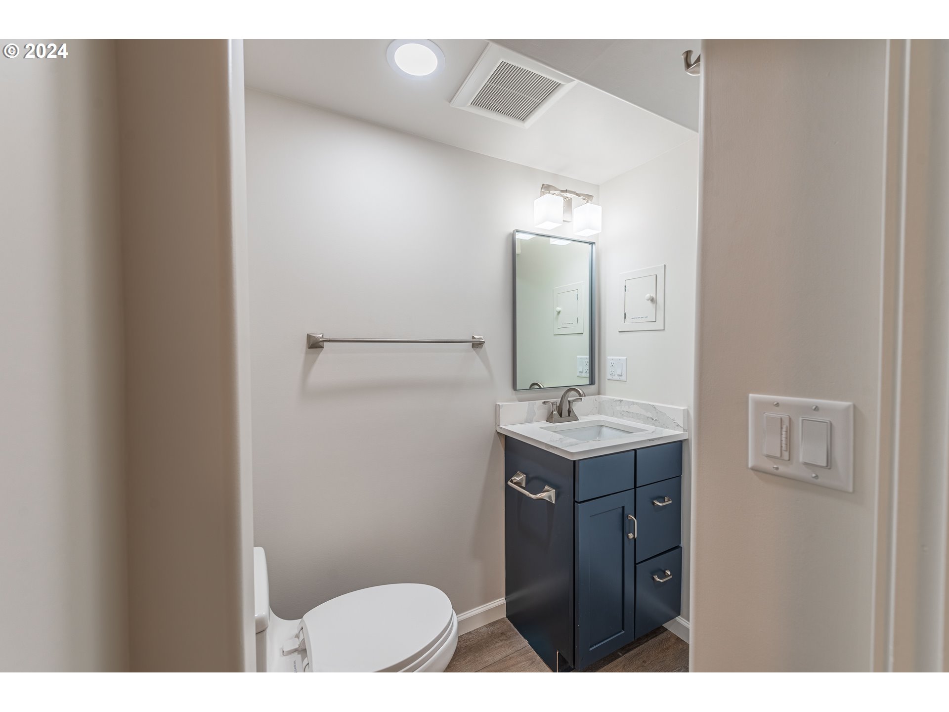 66013 North Bay Road North Bend, OR 97459 - Photo 38 of 48 a bathroom with a sink a toilet and mirror