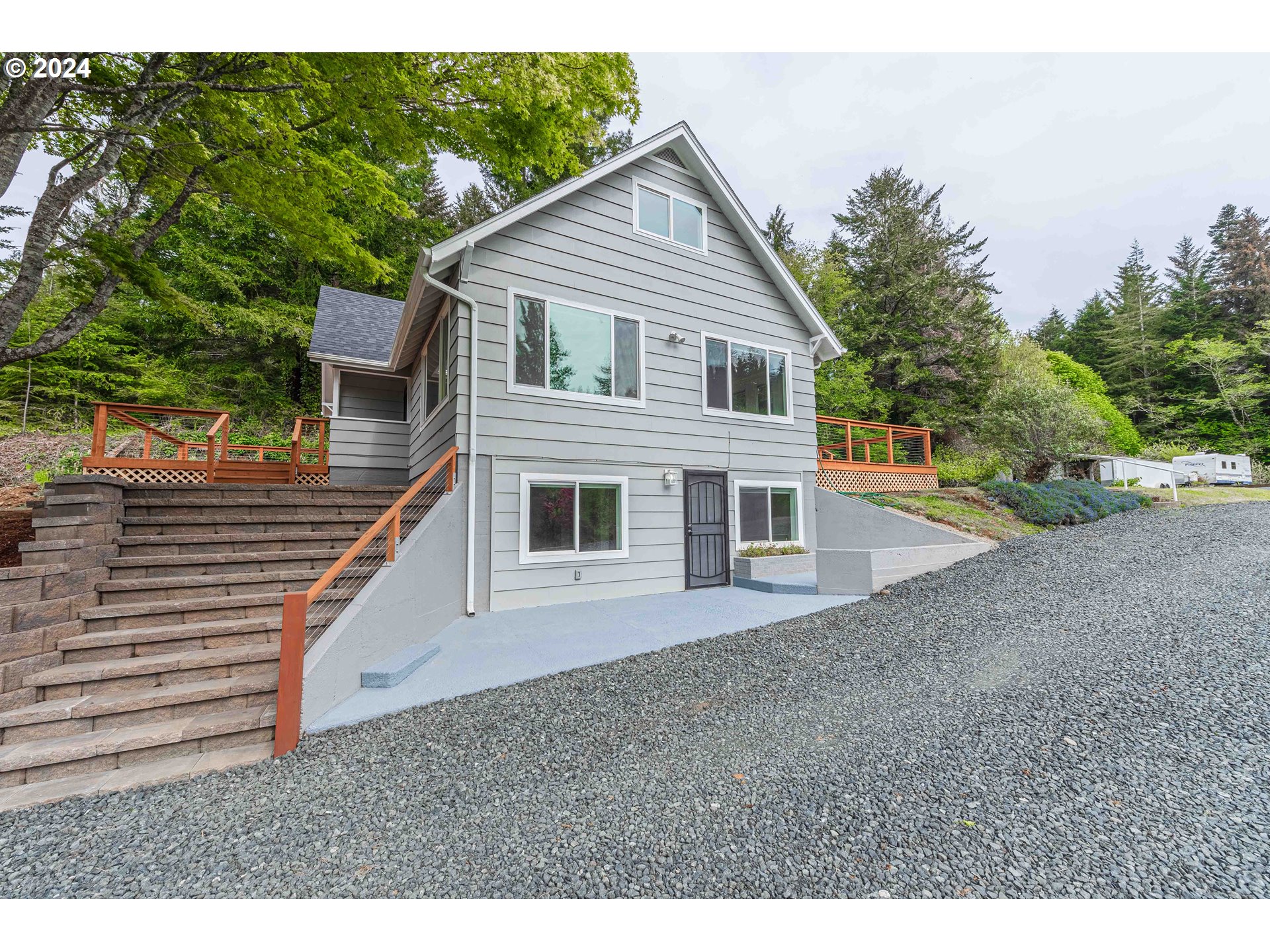 66013 North Bay Road North Bend, OR 97459 - Photo 4 of 48 a view of a house with a yard