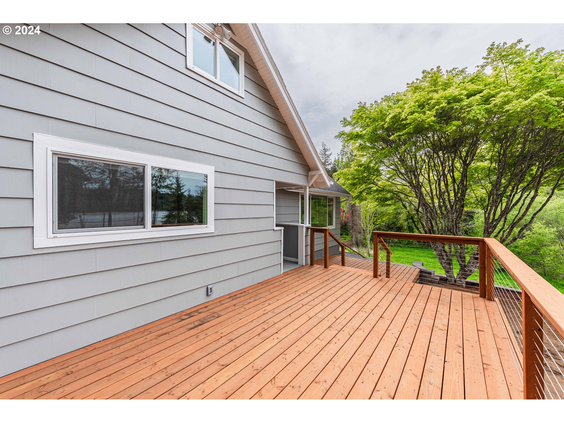 66013 North Bay Road North Bend, OR 97459 - Photo 41 of 48 a balcony with view of wooden floor and seating space
