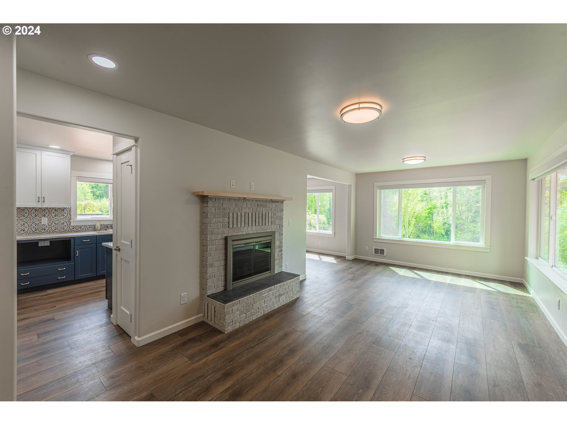 66013 North Bay Road North Bend, OR 97459 - Photo 8 of 48 a view of an empty room with a window and wooden floor