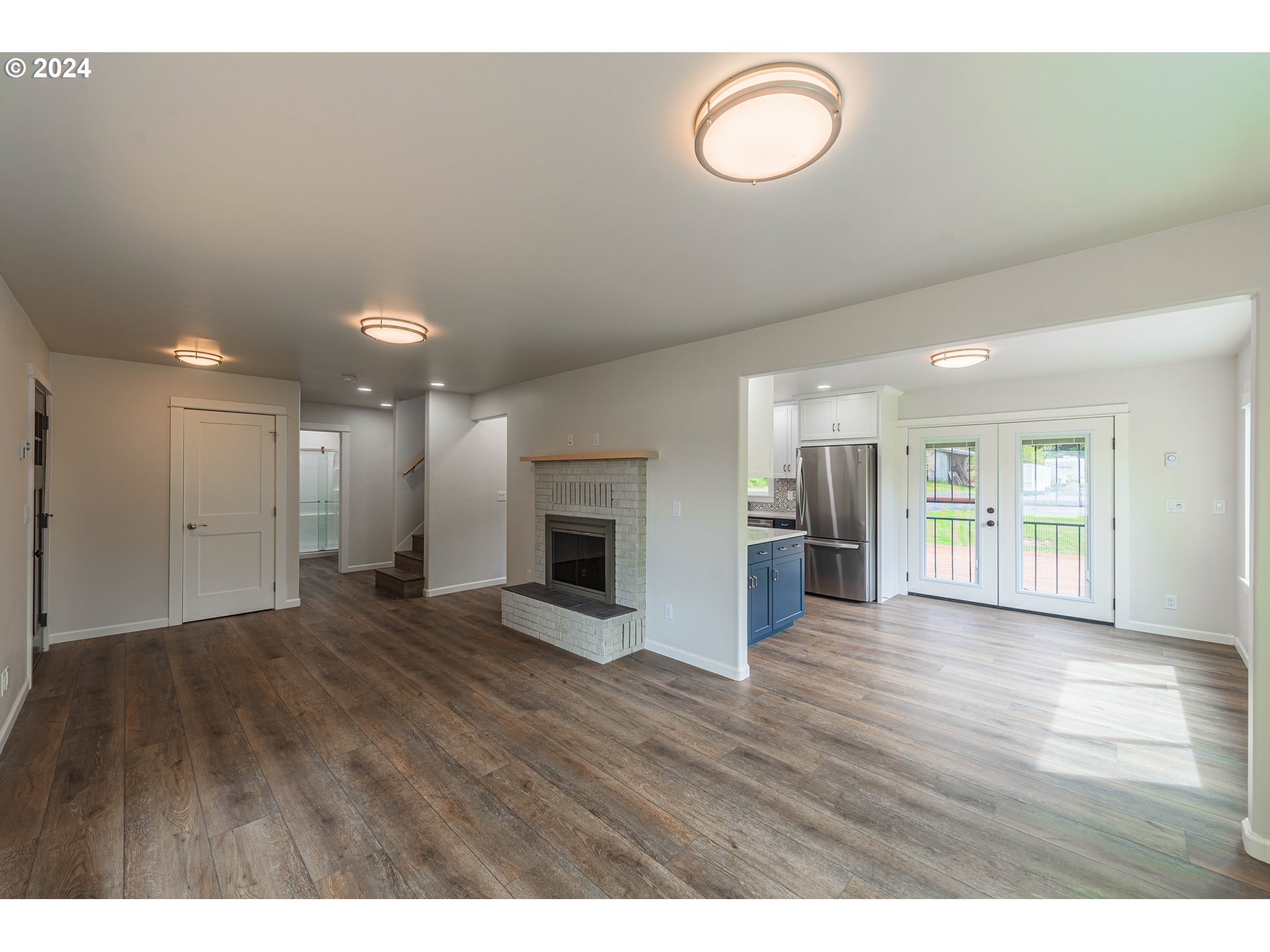 66013 North Bay Road North Bend, OR 97459 - Photo 9 of 48 a view of an empty room with wooden floor and a window