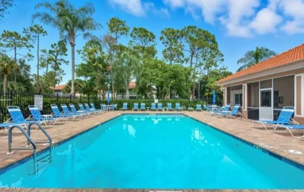 a view of a house with swimming pool and sitting area