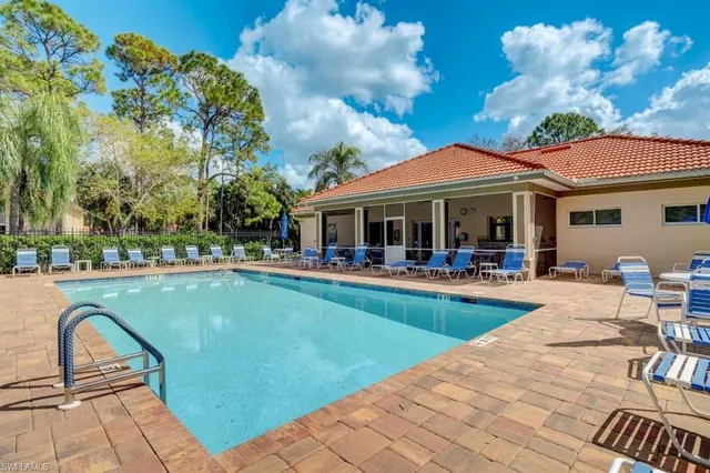 a view of a swimming pool with a patio and a yard